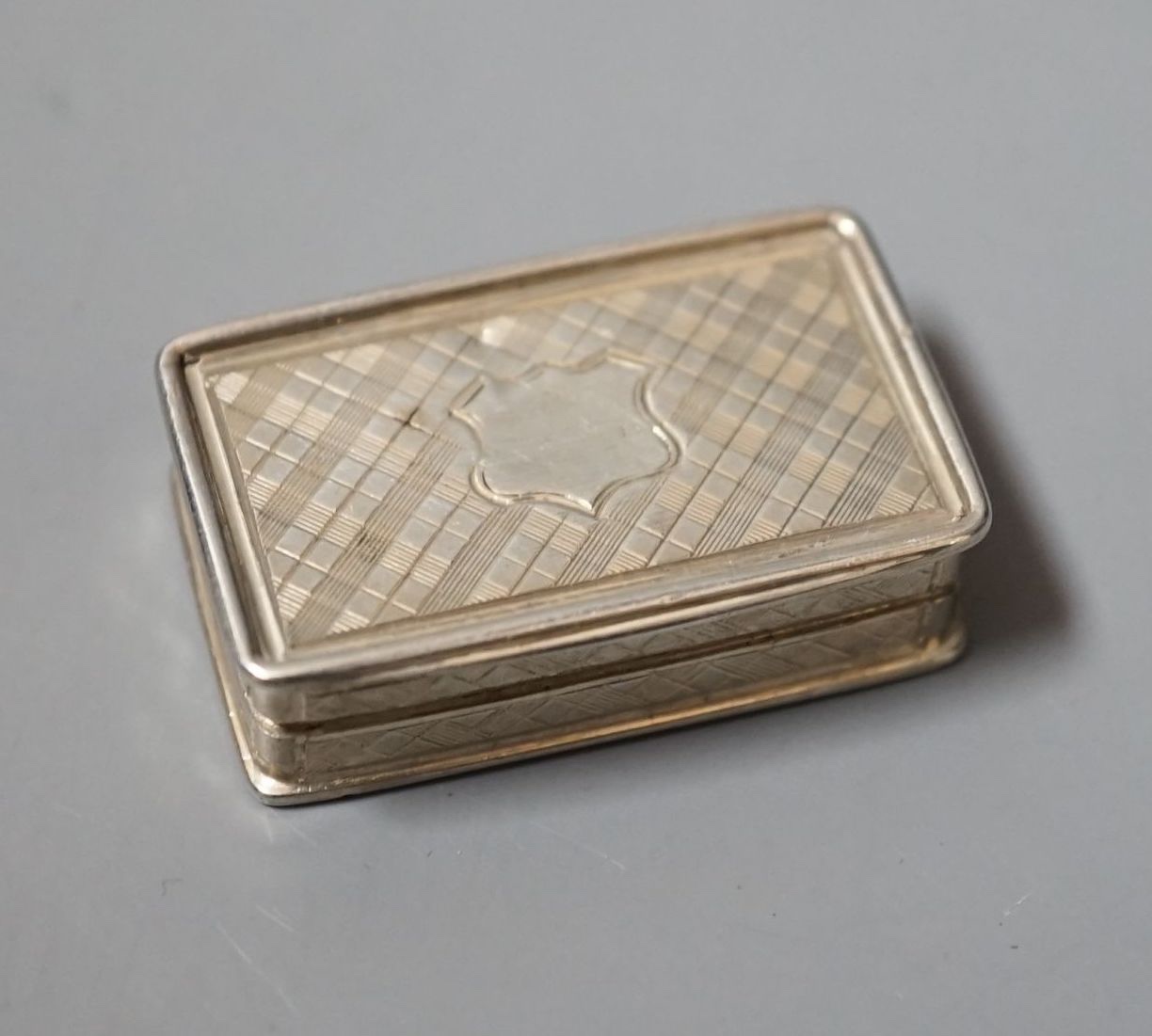 An early Victorian engraved silver rectangular vinaigrette, by Nathaniel Mills, Birmingham, 1839, 34mm.